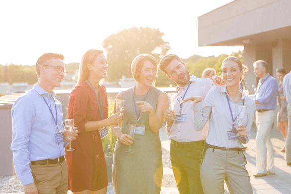a group of corporate people laugh and goof off